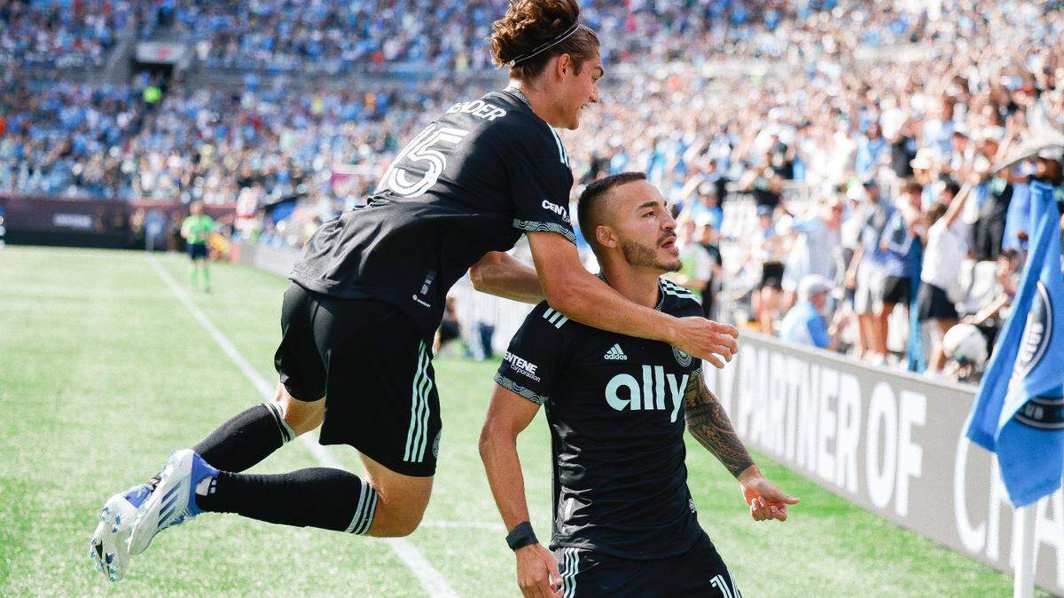 Charlotte FC midfielder Benjamin Bender (15) celebrates a goal with Charlotte FC forward Andre Shinyashiki (16) during a game against the Vancouver Whitecaps at Bank of America Stadium in Charlotte, N.C., Sunday, May 22, 2022.