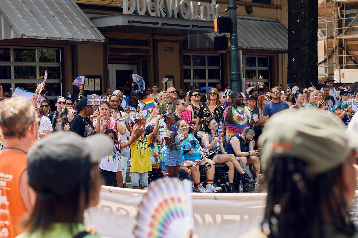 Families take in the sights and sounds during the 25th Charlotte Pride Parade in uptown Charlotte on August 17, 2025.