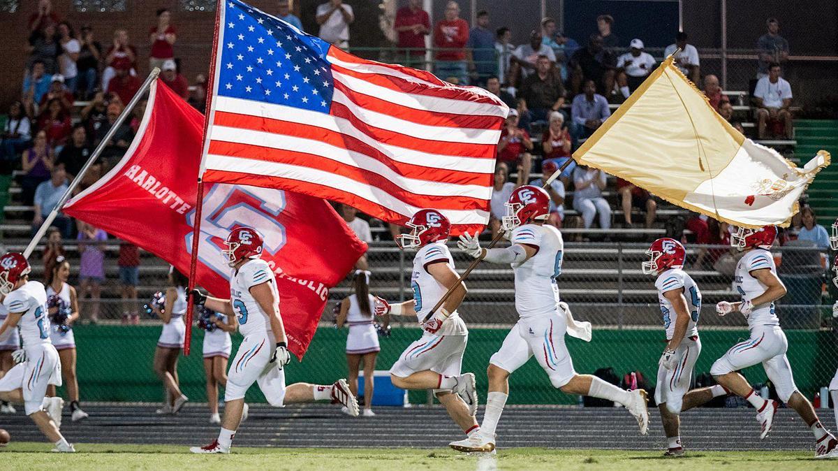 The Catholic Cougars take the field for their game against Weddington.