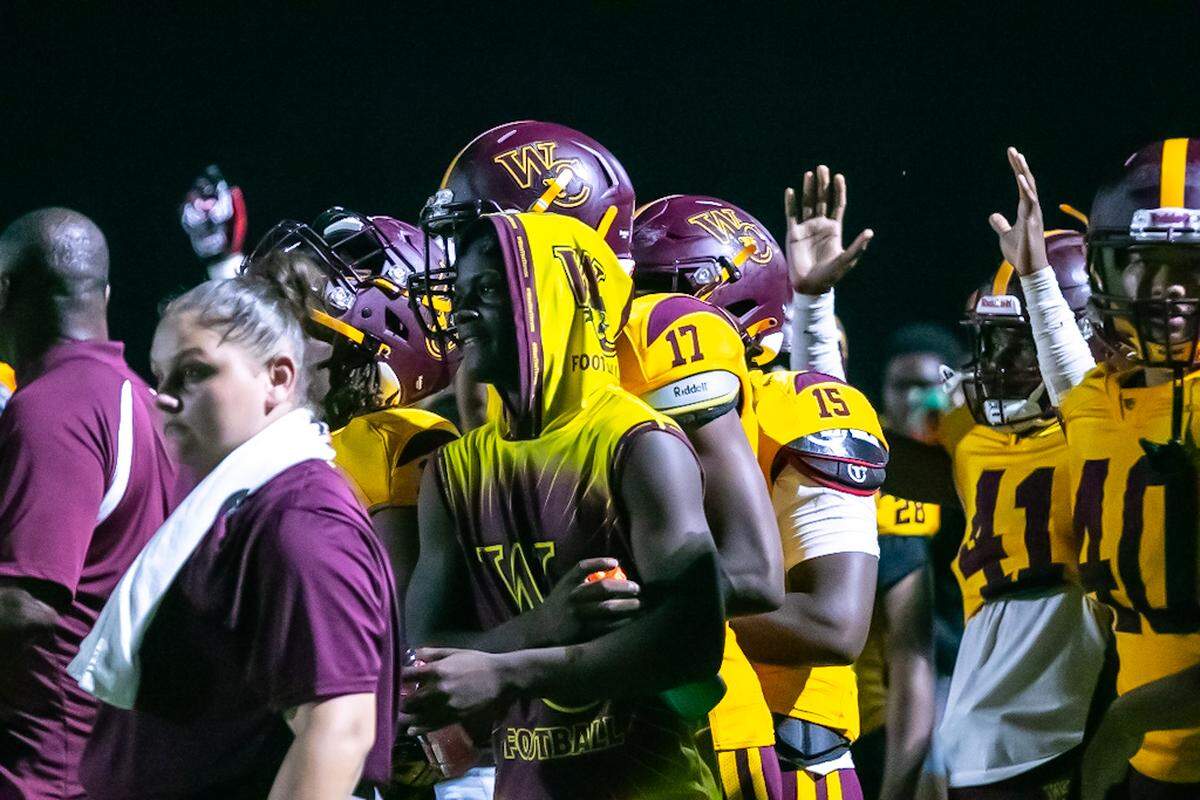 West Charlotte players celebrate a score during Friday’s game with Monroe