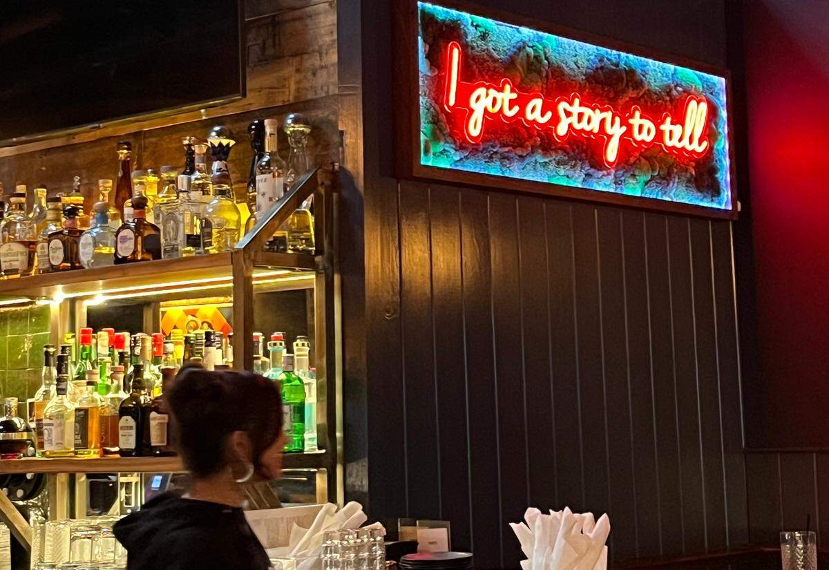 A neon sign glows over the bar at VINYL, referencing the song of the same name by The Notorious B.I.G.