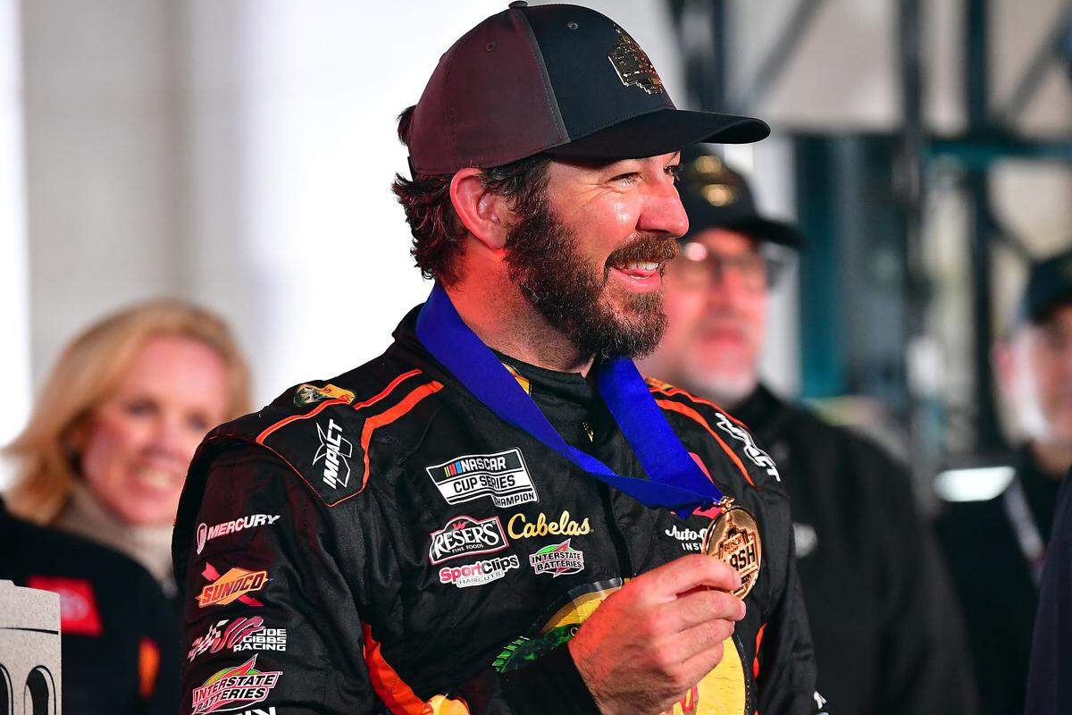 Feb 5, 2023; Los Angeles, California, USA; NASCAR Cup Series driver Martin Truex Jr. (19) celebrates following his victory of the Busch Light Clash at the Los Angeles Memorial Coliseum.