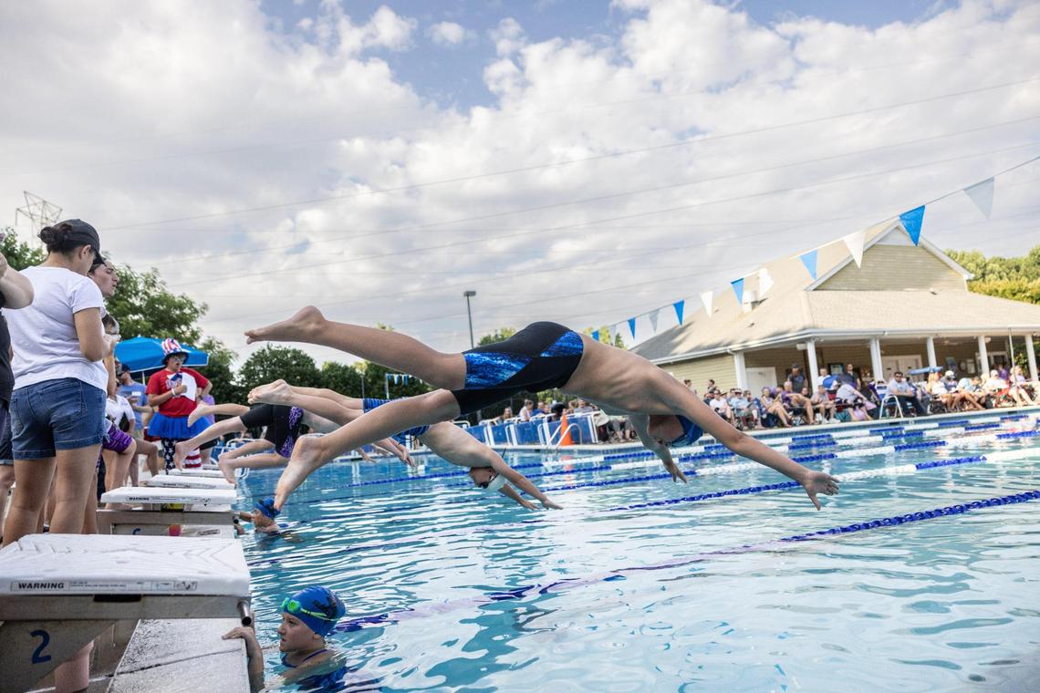 Mike Dumas dives into the pool during a recent swim meet. Mike has been taking puberty-blocking medication since age 9 that prevent him from developing breasts or starting to menstruate.