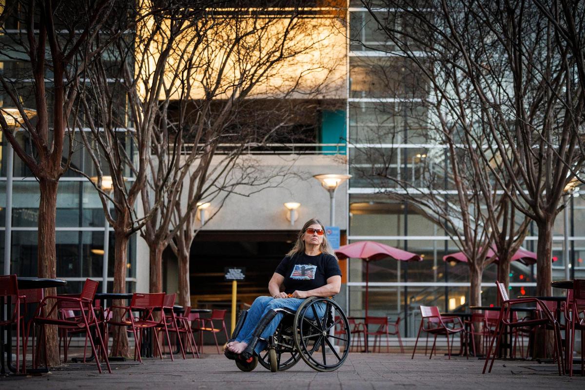 Barbara Ryan, of Charlotte, near in the uptown parking garage where she slept in while briefly homeless in 2019. Ryan, who is paralyzed from the waist down and legally blind, was forcibly evicted from her home in 2019.