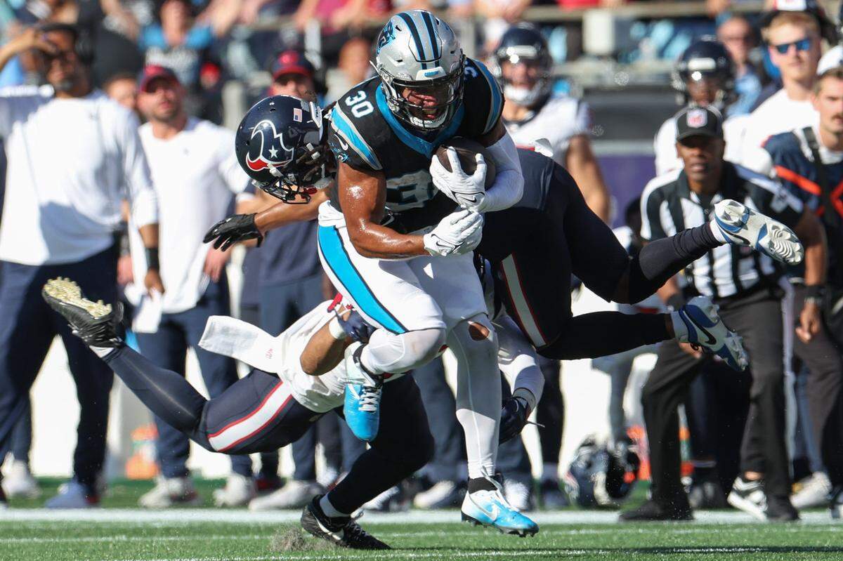 Carolina Panthers running back Chuba Hubbard, center, evades the Texans’ defense during the game at Bank of America Stadium on Sunday, October 29, 2023.