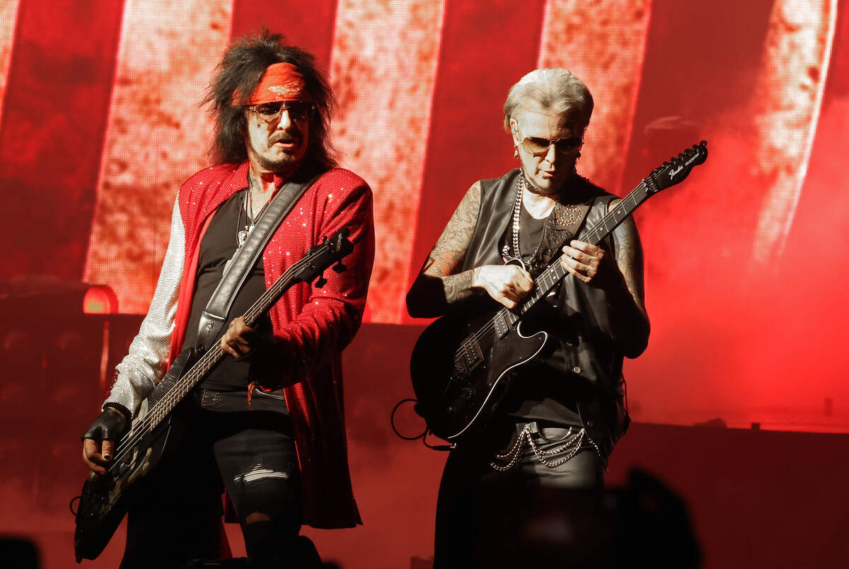 Mötley Crüe bassist Nikki Sixx, left, and lead guitarist John 5 perform during “The Return of the Carnival of Sins” tour at Truliant Amphitheater in Charlotte on Monday night.