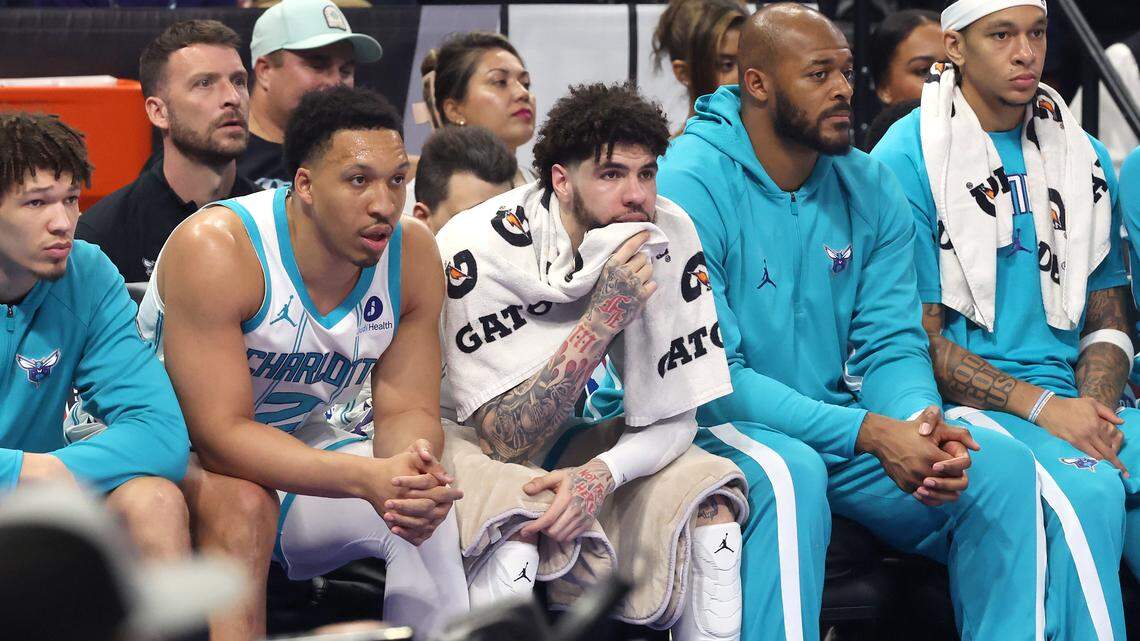 Charlotte Hornets guard LaMelo Ball, center, sits on the bench during first-quarter action against the Orlando Magic at Kia Center in Orlando on Friday. Orlando drubbed the Hornets, 121-90, ending Charlotte’s season.