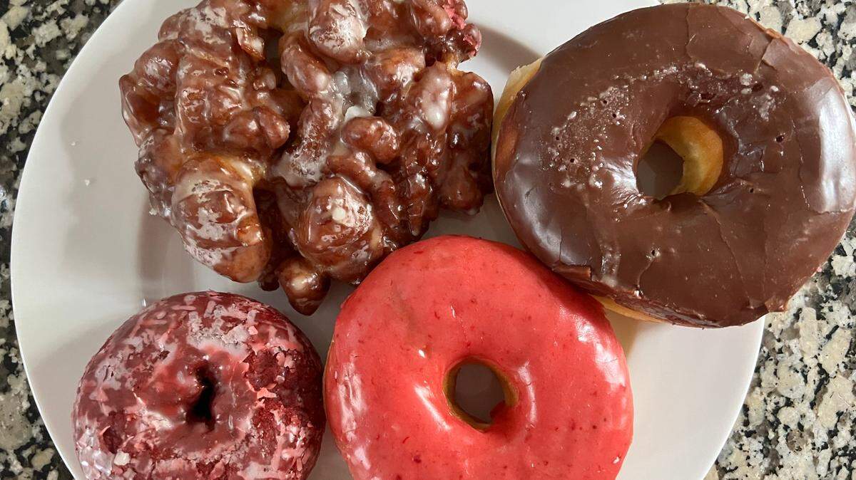 An apple fritter and a selection of doughnuts from MoMo Donuts in Rock Hill. 