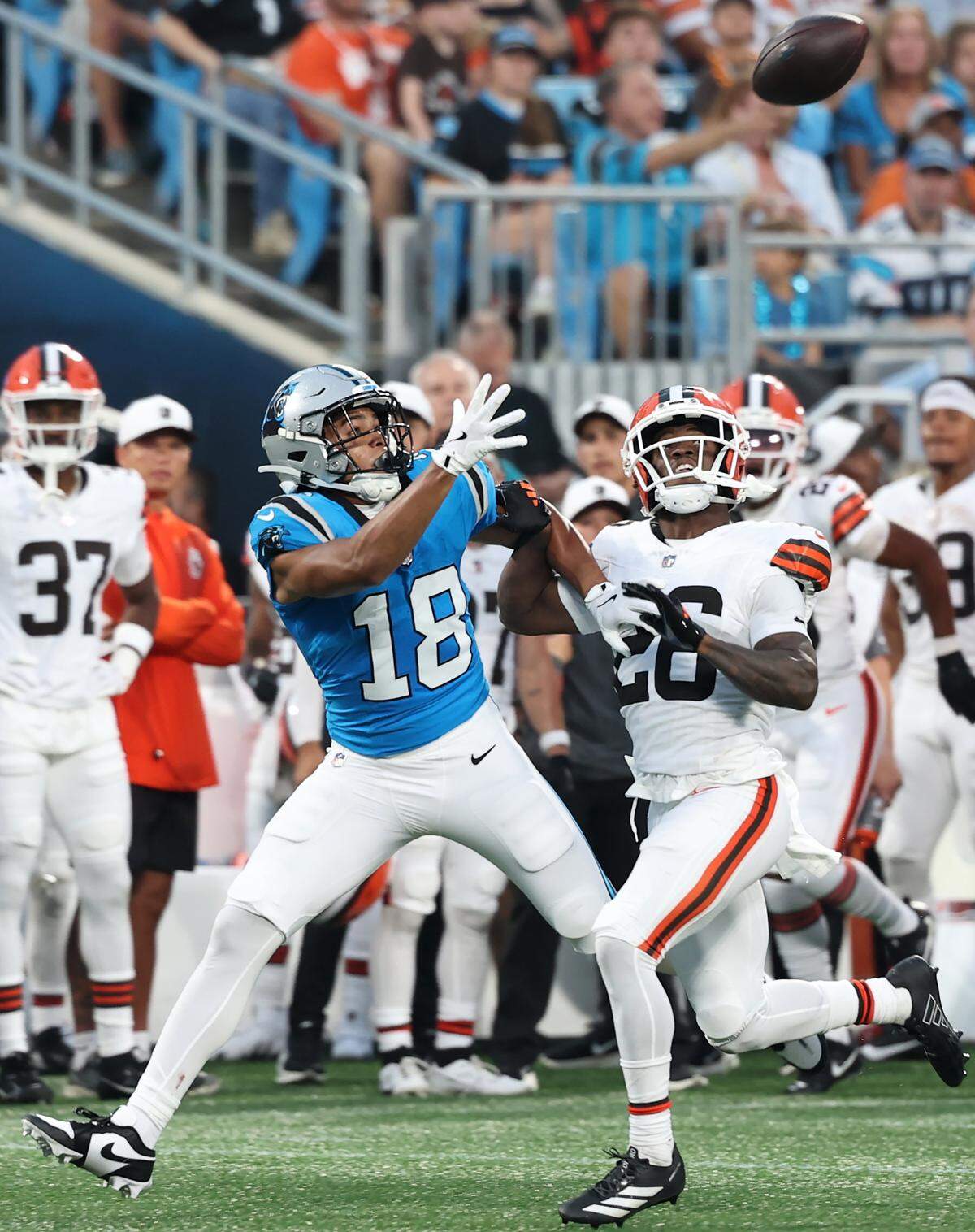 Carolina Panthers wide receiver Jalen Coker, left, fights for position to catch a pass against Cleveland Browns cornerback Myles Harden, right, during action on Aug. 8, 2025, at Bank of America Stadium.