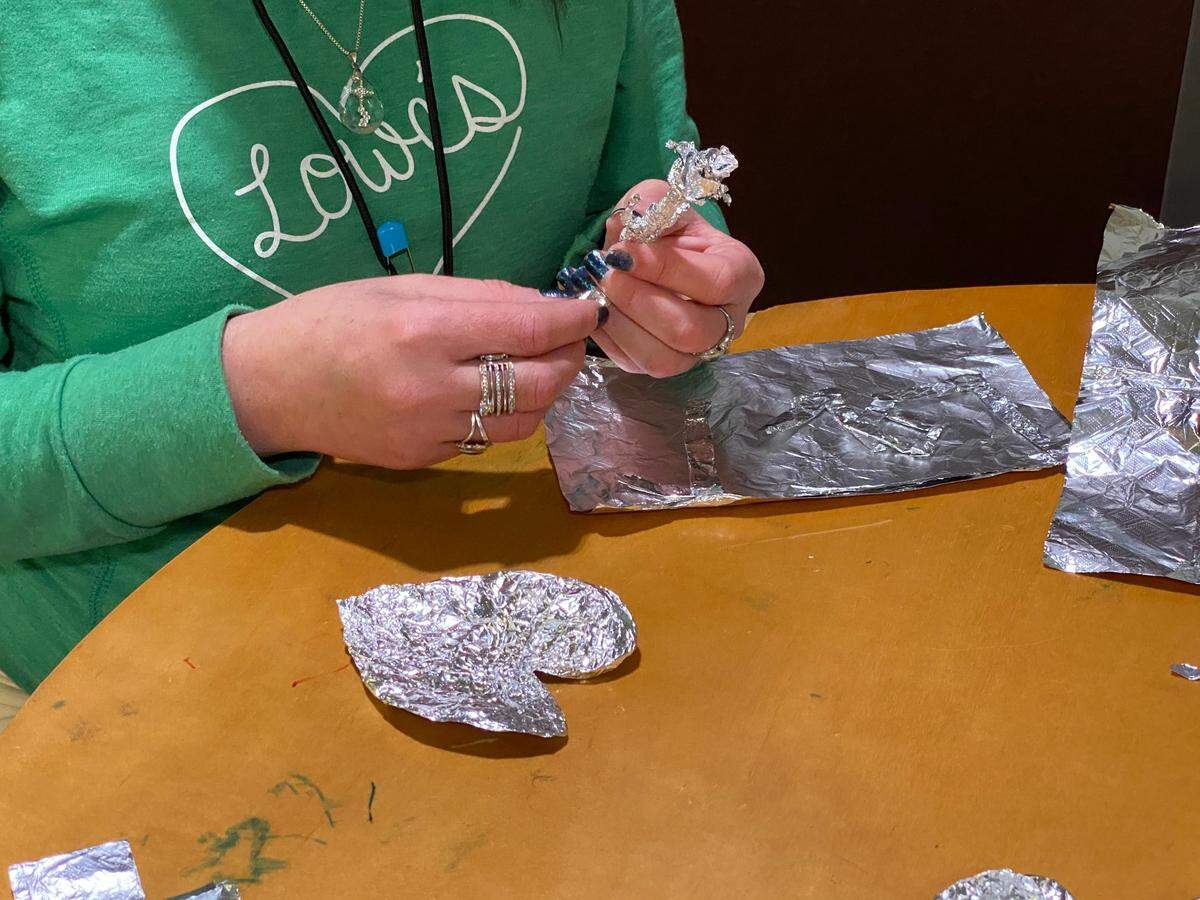 Participants in the “Cathy Create” class at Dove’s Nest often use tin foil to craft whatever comes to mind.