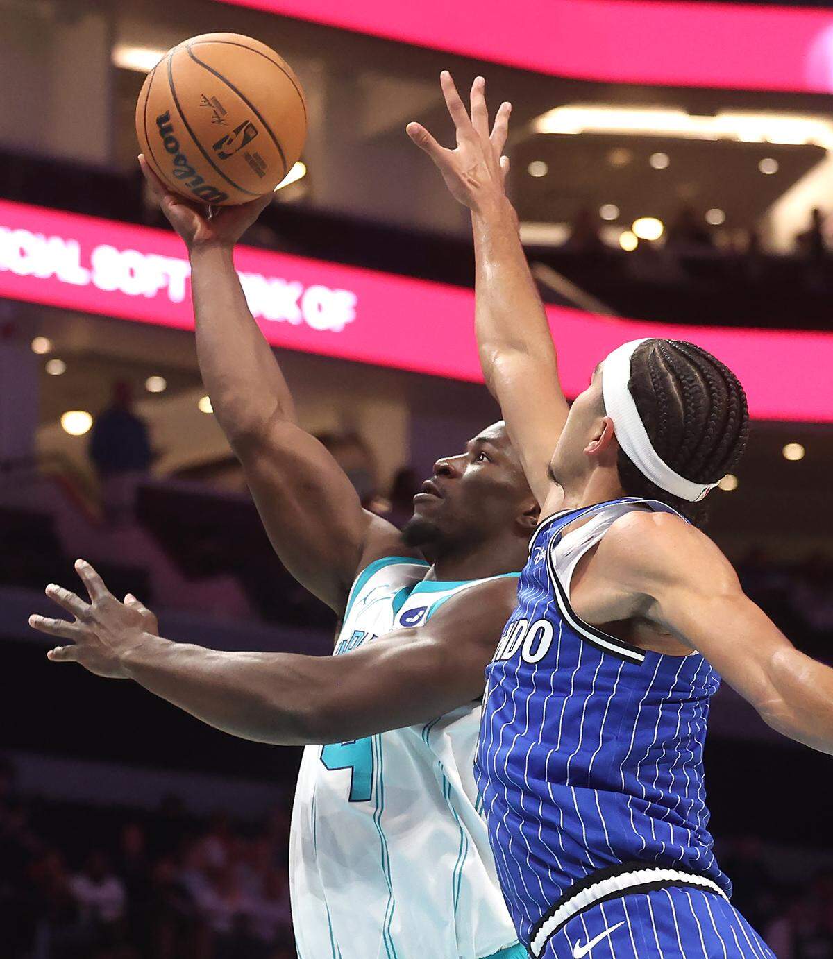 Charlotte Hornets guard Sion James, left, drives to the basket as Orlando Magic guard Anthony Black, right, applies defensive pressure at Spectrum Center in Charlotte, NC on Thursday, October 30, 2025. The Magic defeated the Hornets 123-107.