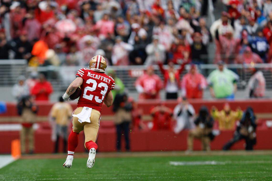 San Francisco 49ers running back Christian McCaffrey (23) runs against the Seattle Seahawks Sunday in a playoff win.