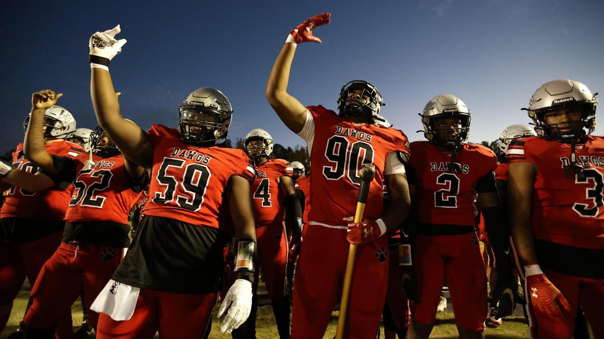 Butler’s Jadyn Farmer (90) and Caleb Scull (59) get ready to take the field with the team before taking on the Independence Patriots for the Southwestern 4A title at Butler High School on October 27, 2023.