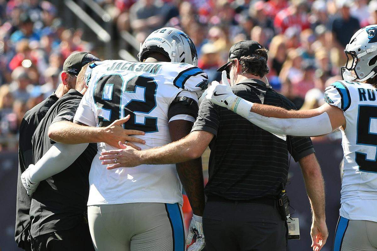 Carolina Panthers defensive end Tershawn Wharton (92) is helped off the field during Sunday’s first half at Gillette Stadium.