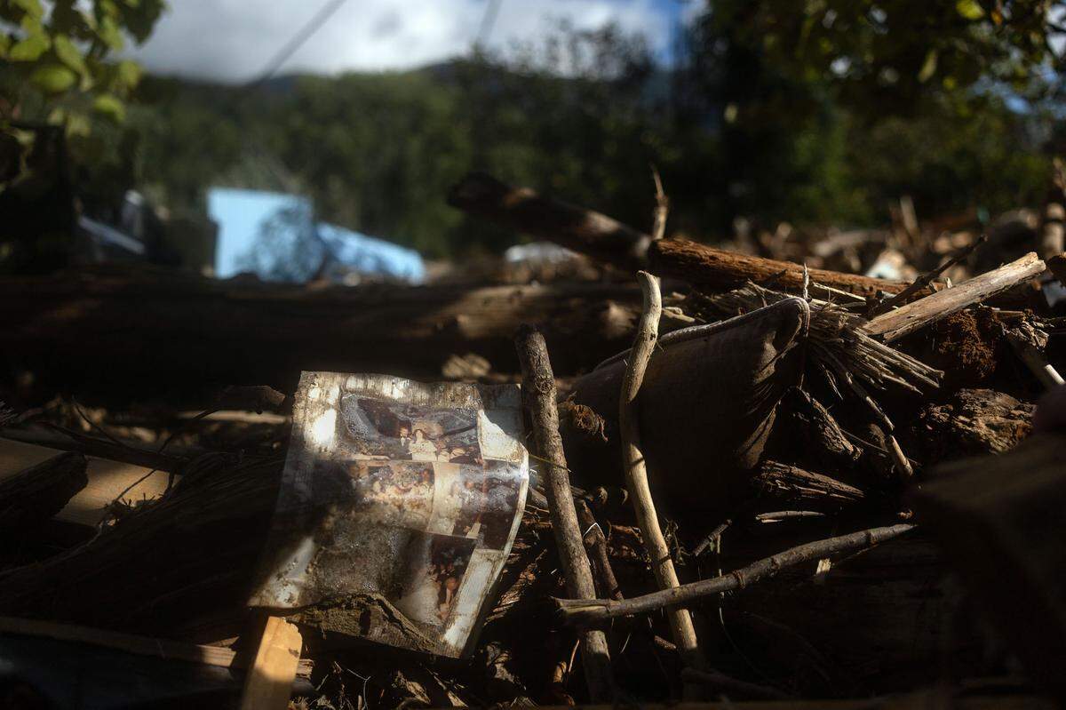 A collage of wedding photos sits on a rubble in Lake Lure, N.C. on Sunday, September 29, 2024.