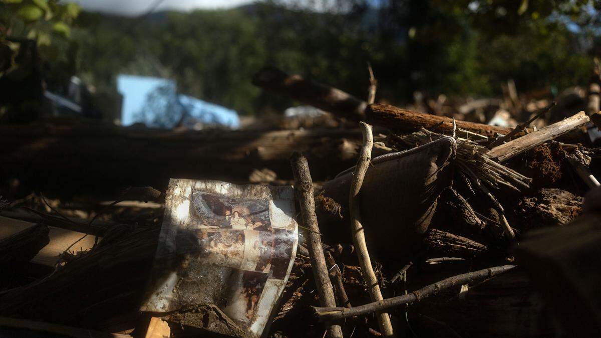 A collage of wedding photos sits on a rubble in Lake Lure, N.C. on Sunday, September 29, 2024.