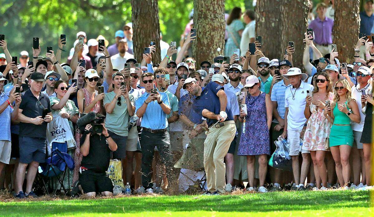 I-phones abound as the gallery watches golfer Scottie Scheffler, center, chip out of the rough to the second green during the final round of the PGA Championship at Quail Hollow Club in Charlotte on Sunday, May 18, 2025.
