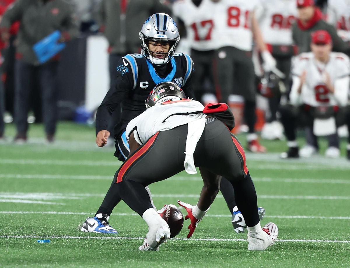 Carolina Panthers quarterback Bryce Young watches as Tampa Bay Buccaneers linebacker Yaya Diaby picks up the ball fumbled by Panthers running back Chuba Hubbard during overtime at Bank of America Stadium in Charlotte, NC on Sunday, December 1, 2024. The Buccaneers defeated the Panthers 26-23. Young called his decision not to try to jump on the fumble “just a reaction.”