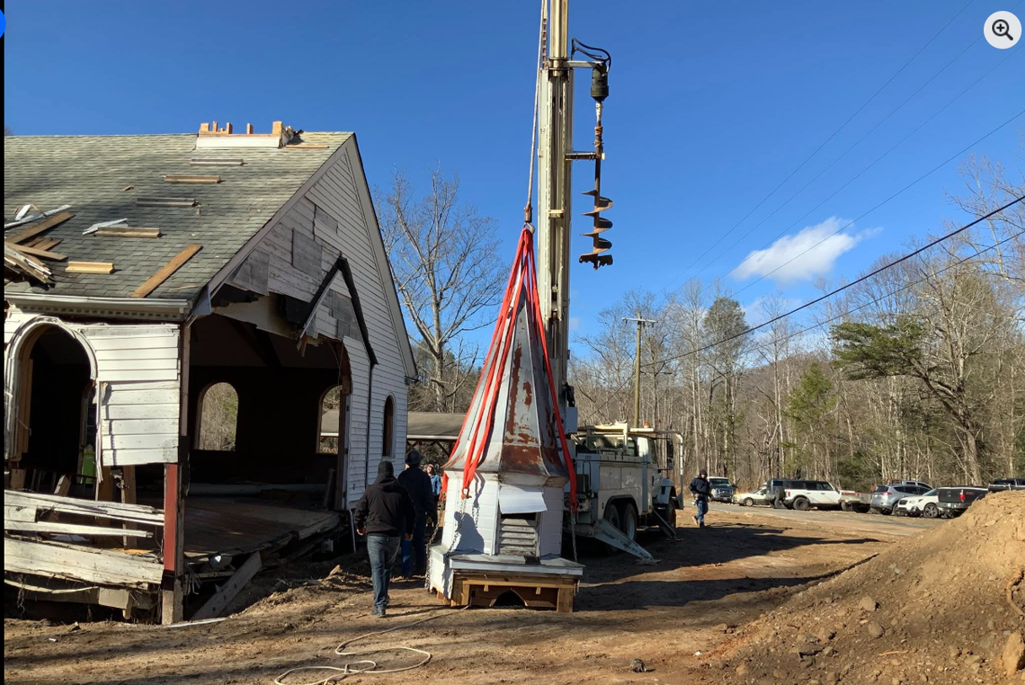 The 15-foot tall steeple was lifted off the church and placed gently on the ground. It will soon be taken to a warehouse to be refurbished, officials say.