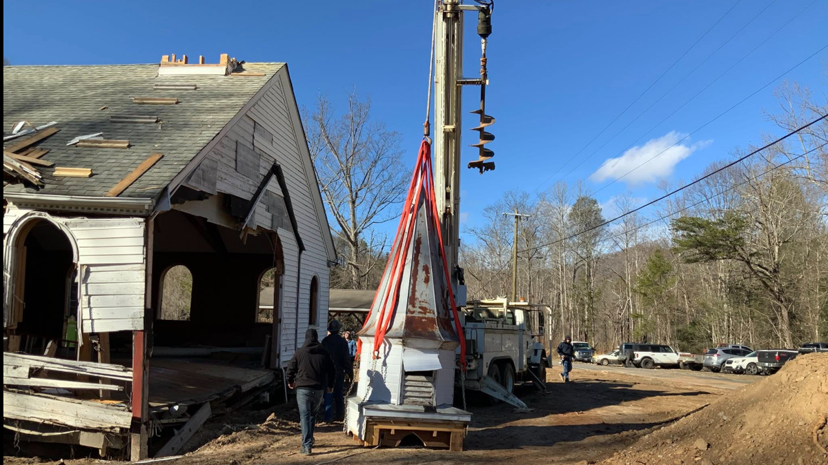 The 15-foot tall steeple was lifted off the church and placed gently on the ground. It will soon be taken to a warehouse to be refurbished, officials say.