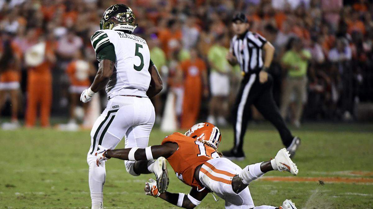 Safety Denzel Johnson #14 of the Clemson Tigers trips up running back Aaron McAllister #5 of the Charlotte 49ers during their football game at Memorial Stadium on September 21, 2019 in Clemson, South Carolina. (Mike Comer/Getty Images/TNS)