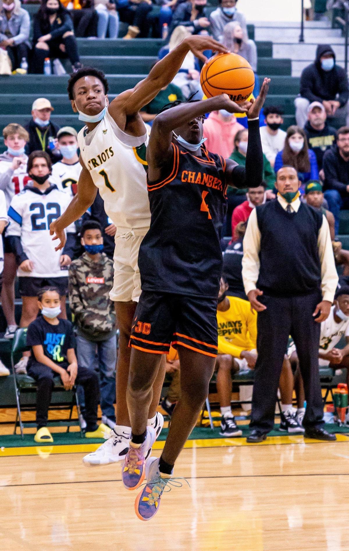 Independence HighÕs Ralph Johnson blocks a jump shot by ChambersÕ Kendall Smith during the season opener at Independence High School in Charlotte, NC on Monday, November 22, 2021.