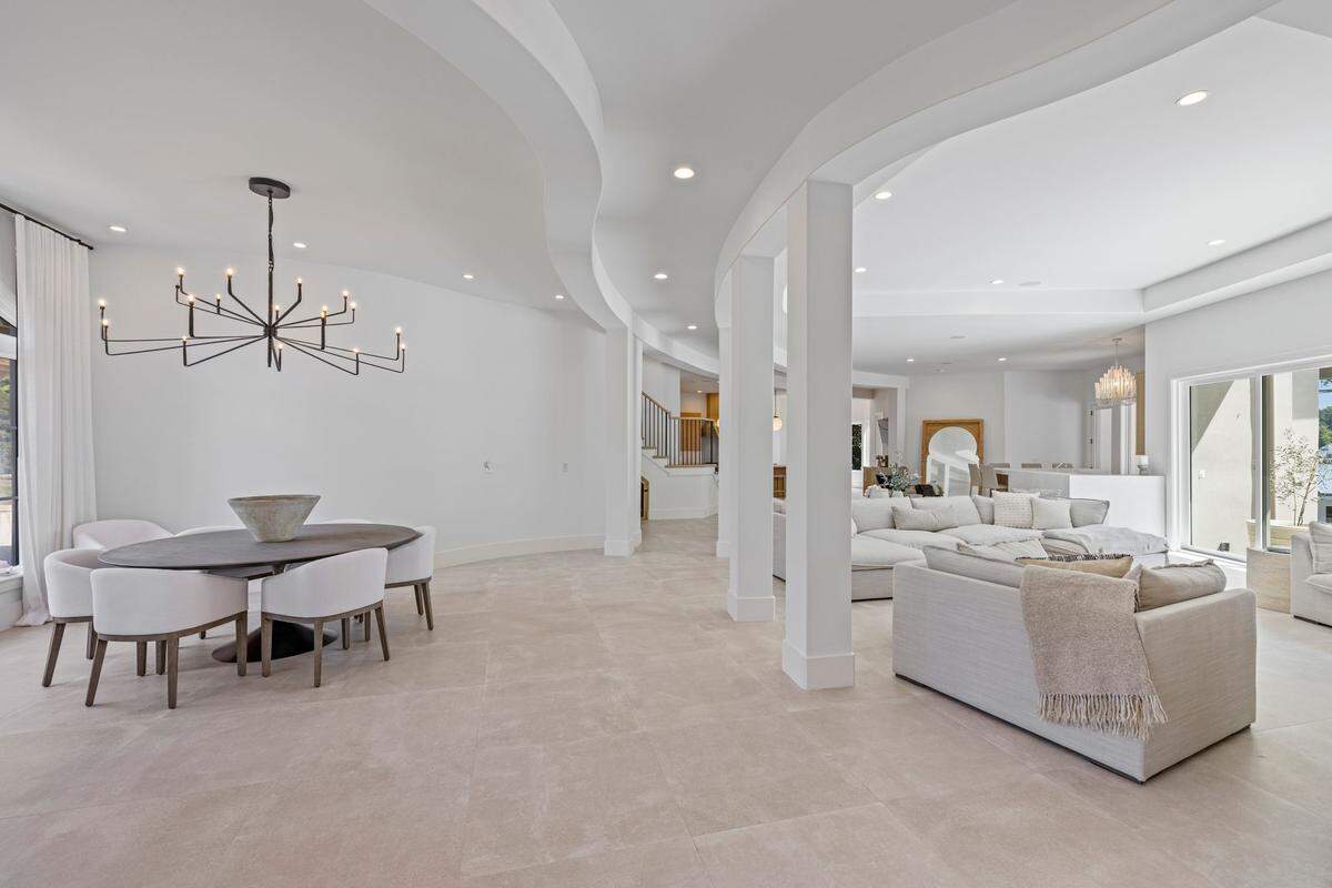 The home’s open-concept layout is anchored by a chef’s kitchen with professional-grade, stainless steel appliances, and an expansive family room, according to the listing.