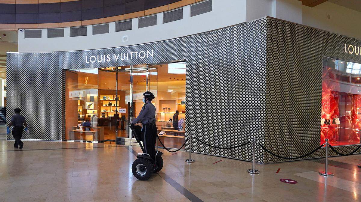 A mall security officer passes by the Louis Vuitton store at SouthPark mall prior to reopening on Saturday, May 9, 2020. SouthPark mall, along with Simon Property Group’s other NC malls and outlets, including Concord Mills mall and Charlotte Premium Outlets, reopened on Saturday. The malls are allowed to reopen under phase 1 of Gov. Roy Cooper’s opening of North Carolina order. The mall had been closed since March 18, 2020, due to the COVID-19 pandemic.