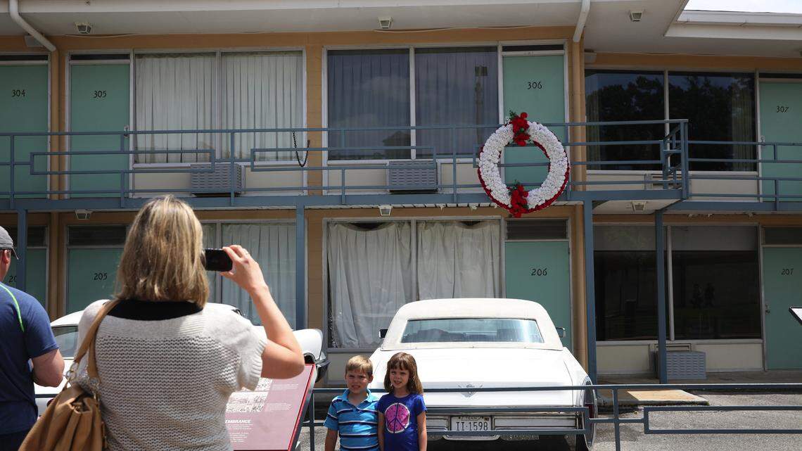 A family takes a photo outside of the National Civil Rights Museum, which is housed in what used to be the Lorraine Motel, where Martin Luther King was assassinated in Memphis.