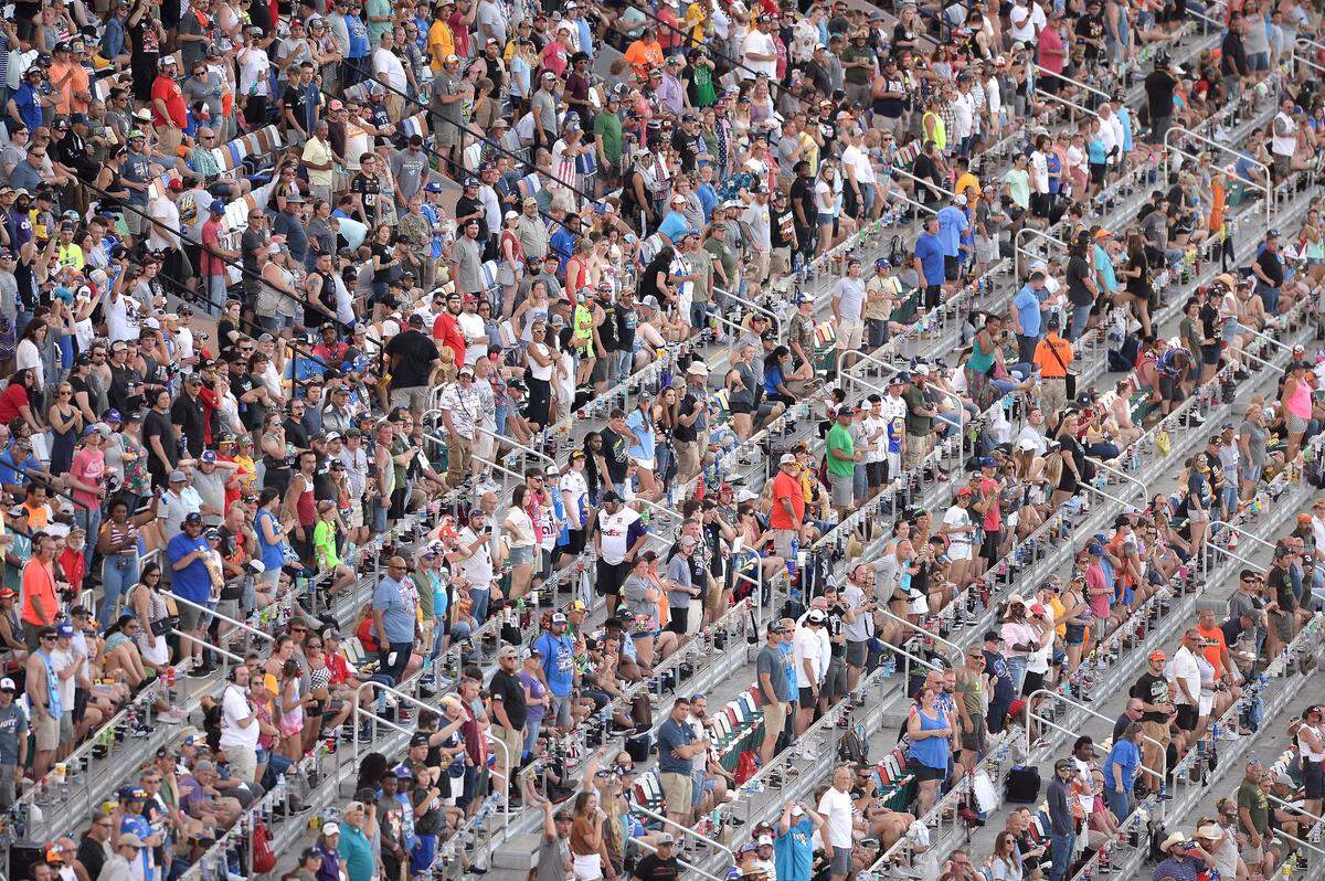 NASCAR fans rise to watch the restart of the Coca-Cola 600 following a caution at Charlotte Motor Speedway in Concord, NC on Sunday, May 29, 2022.