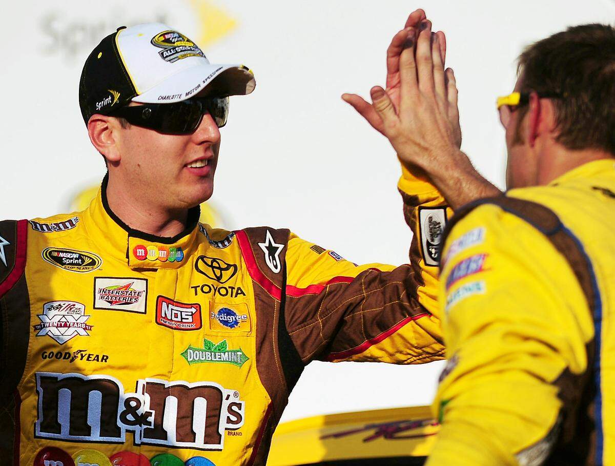 5/20/11 NASCAR Sprint Cup Series driver Kyle Busch slaps hands with his crew members after winning the pole for the Sprint All-Star Race Friday at Charlotte Motor Speedway. Jeff Siner - jsiner@charlotteobserver.com
