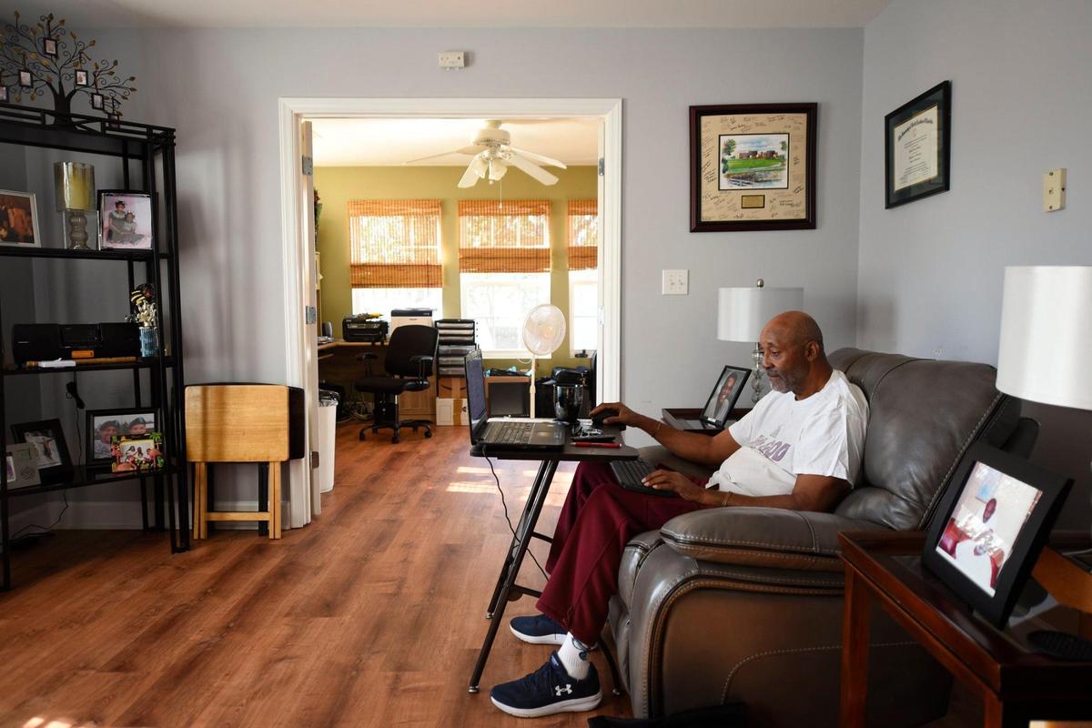 John Sadler, of Charlotte, N.C. browses Ancestry.com and takes notes while searching through family history at his home in Charlotte, N.C. Monday, Feb. 14, 2022. Sadler, 69, has been researching family history for decades, but began to take it more seriously after retiring from Duke Energy in 2018. He has published multiple books on his family history and one on genealogy and hopes to leave a lasting memory for his family, “Everybody has a desire and a need to know from whence they came,” he said.