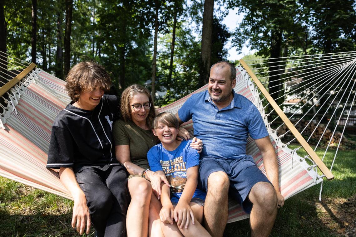 The Dumas family -- TJ, Amanda, Mike and Josh -- pose for a portrait in their backyard.