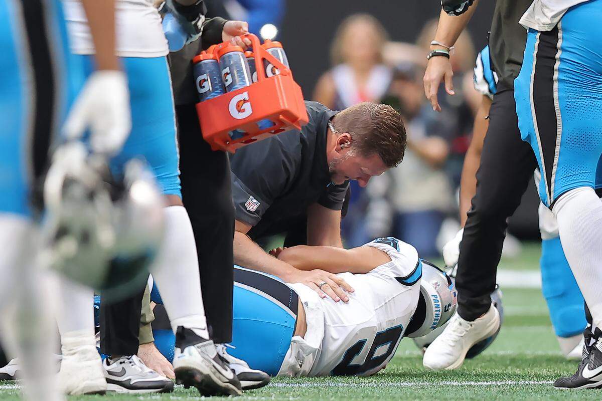 A medical staffer checks out Carolina Panthers QB Bryce Young during Sunday’s first quarter against the Atlanta Falcons at Mercedes-Benz Stadium in Atlanta. Young briefly left the field after injuring his ankle but never missed an offensive snap.