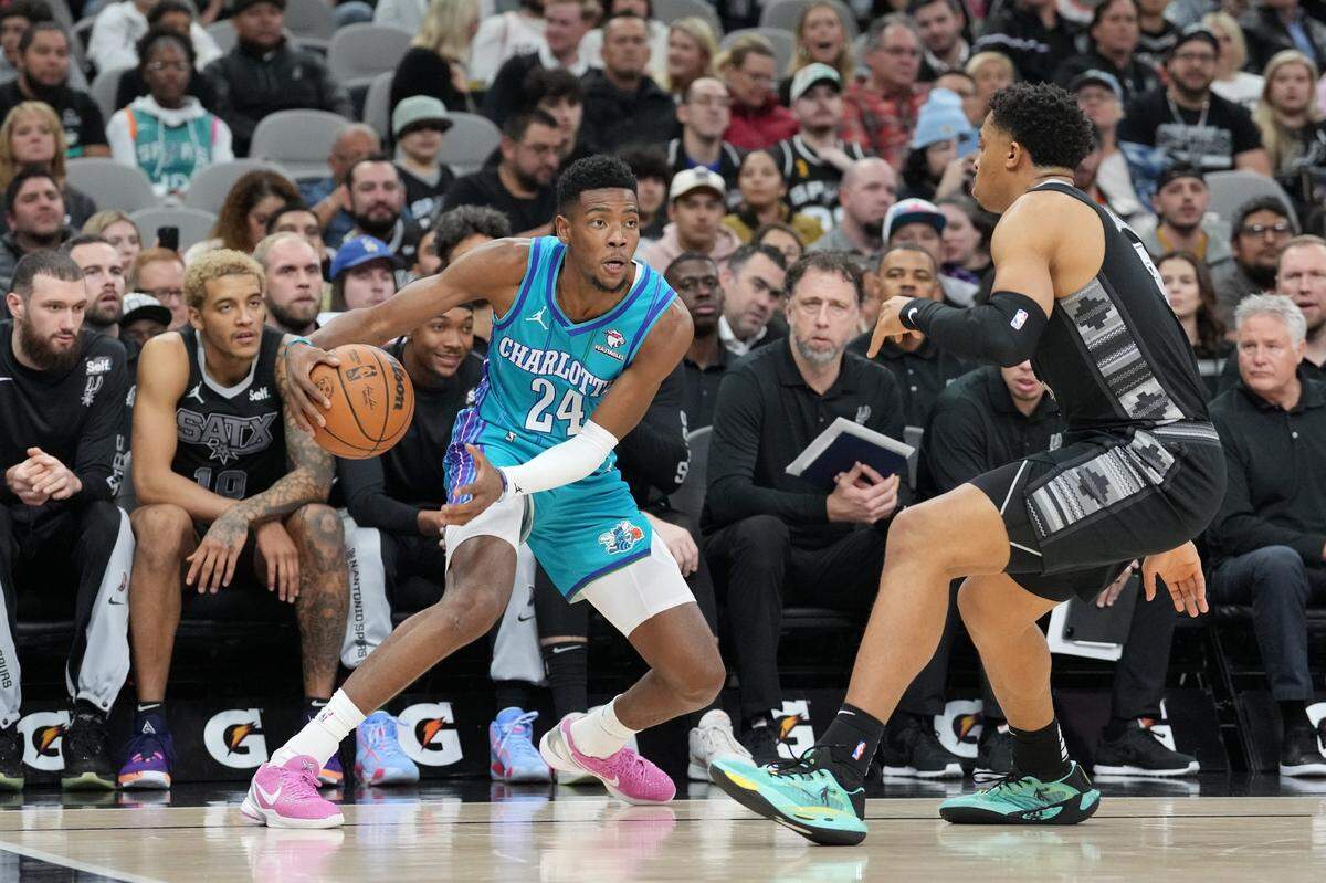 Charlotte Hornets guard Brandon Miller (24) dribbles against San Antonio Spurs forward Keldon Johnson (3) in the first half at Frost Bank Center.