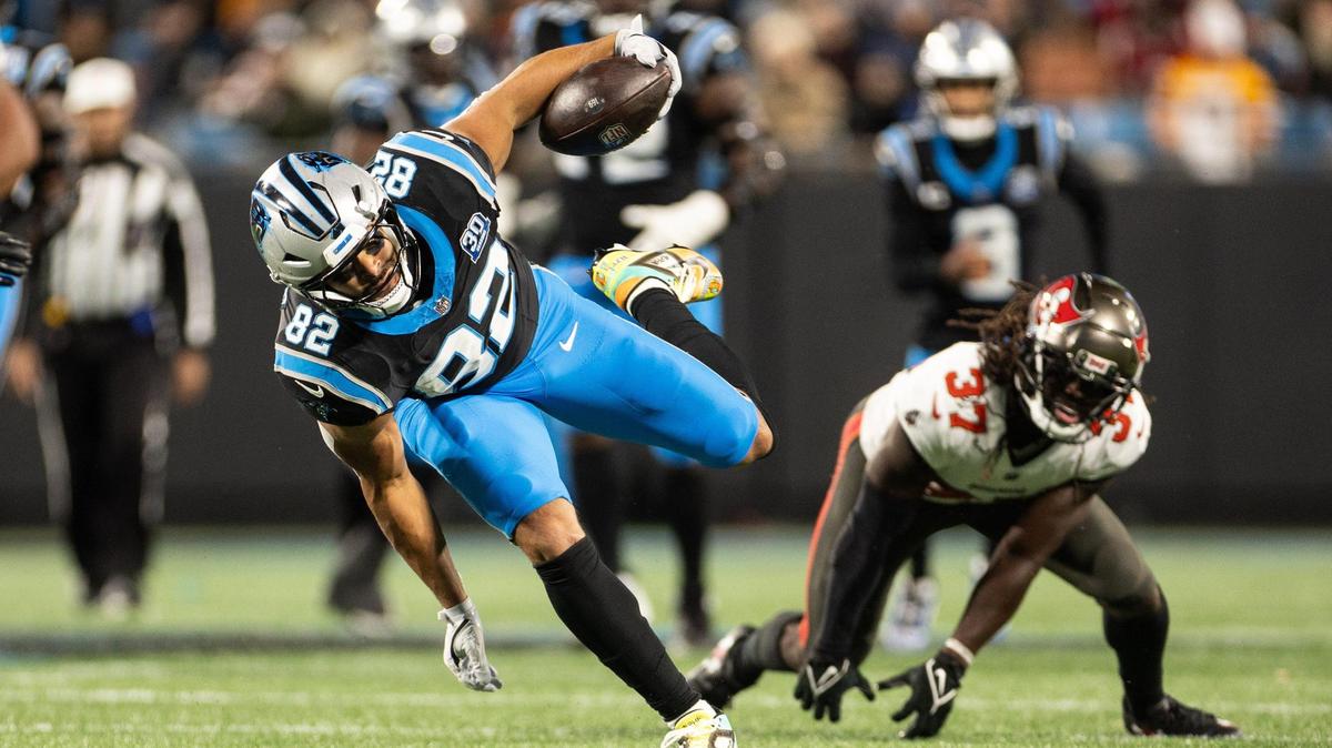 Carolina Panthers tight end Tommy Tremble, left, avoids a tackle by Tampa Bay Buccaneers cornerback Tavierre Thomas at the Bank of America Stadium in Charlotte, N.C., on Sunday, December 1, 2024.