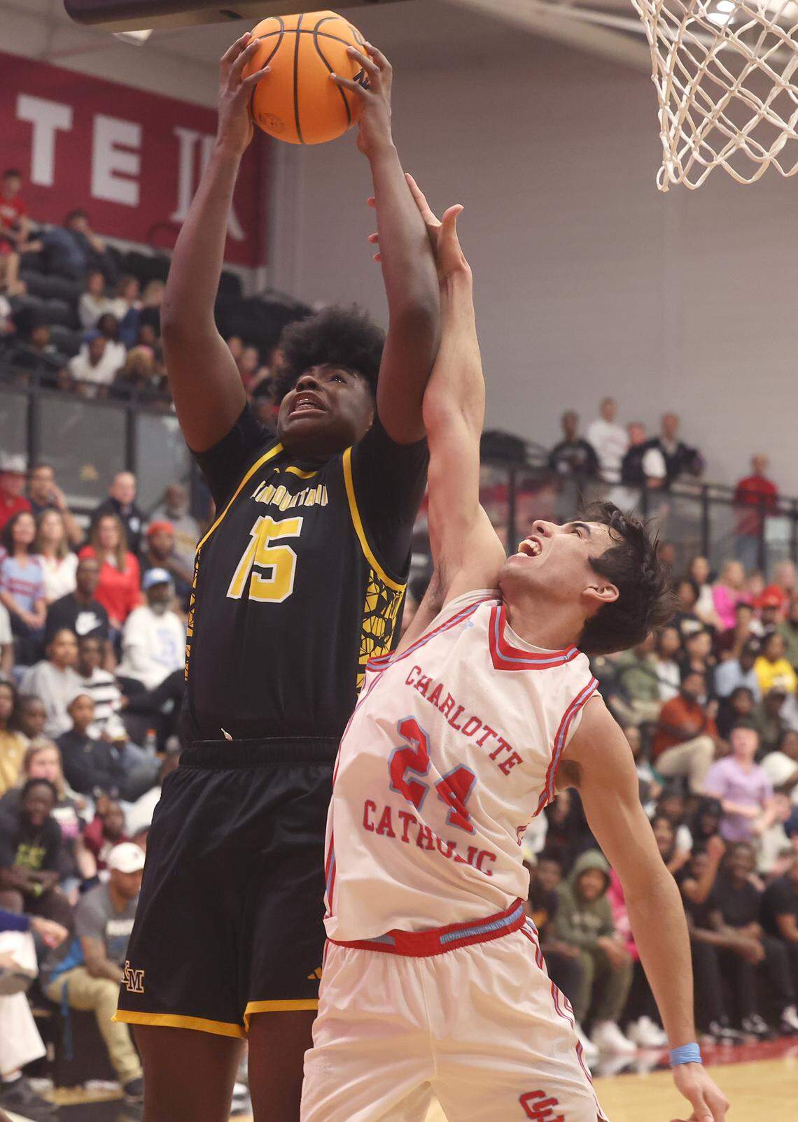 Kings Mountain’s Micaiah Daniel, left, pulls down a rebound over Charlotte Catholic’s Keaton McKinstry, right, during the NCHSAA 6A boy’s regional championship game on Wednesday, March 4, 2026 at Lenoir-Rhyne University in Hickory, NC. Kings Mountain defeated Charlotte Catholic 68-61.