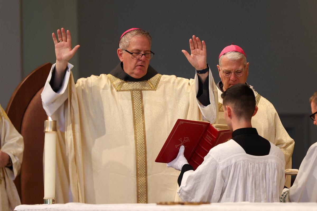 Bishop Michael T. Martin reads from gives a solemn blessing to end of mass at Saint Mark Catholic Church in Huntersville on May 29, 2024.
