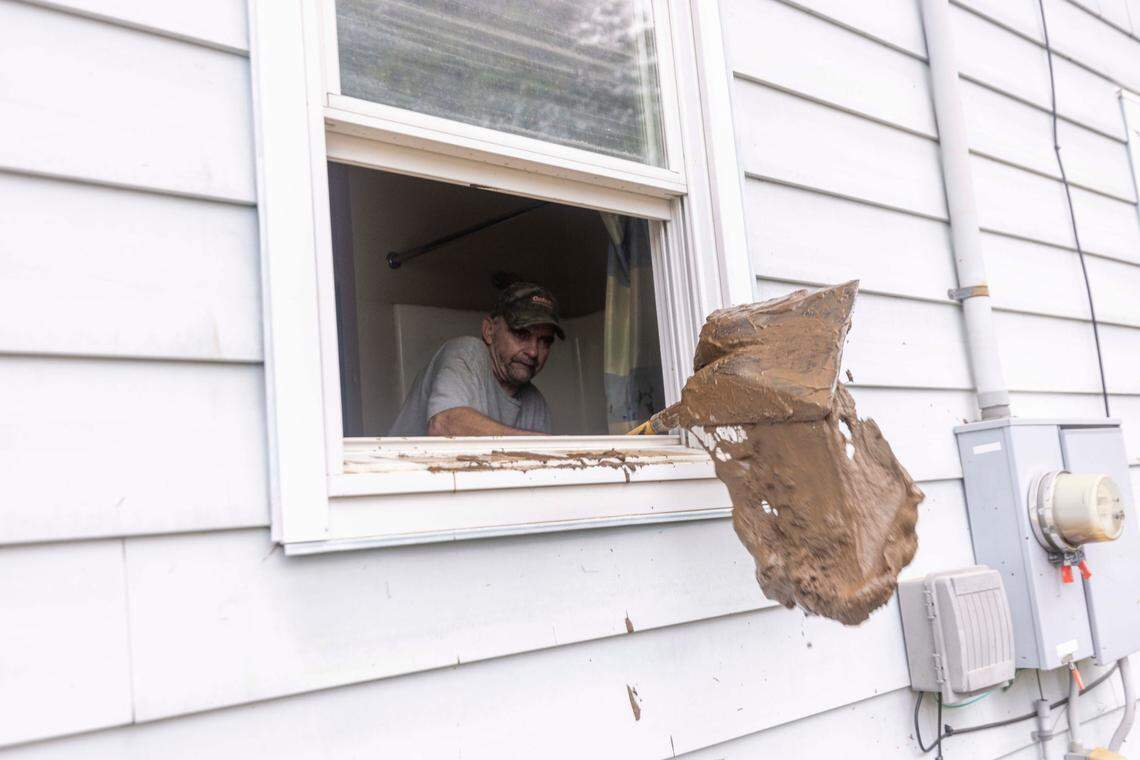 Alan Tabor shovels mud from a flooded home in Clyde on Saturday, Sept. 28, 2024 after massive flooding damaged dozens of homes and businesses. The remnants of Hurricane Helene caused widespread flooding, downed trees, and power outages in western North Carolina.