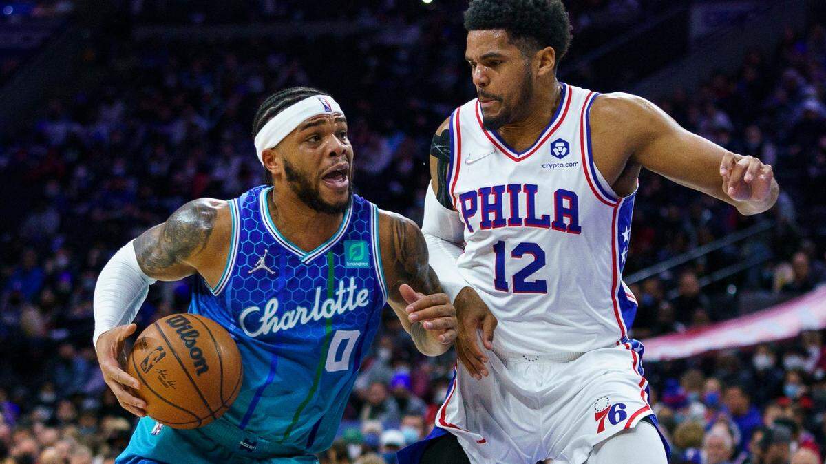 Charlotte Hornets’ Miles Bridges, left, drives to the basket against Philadelphia 76ers’ Tobias Harris, right, during the first half of an NBA basketball game, Wednesday, Jan. 12, 2022, in Philadelphia. (AP Photo/Chris Szagola)