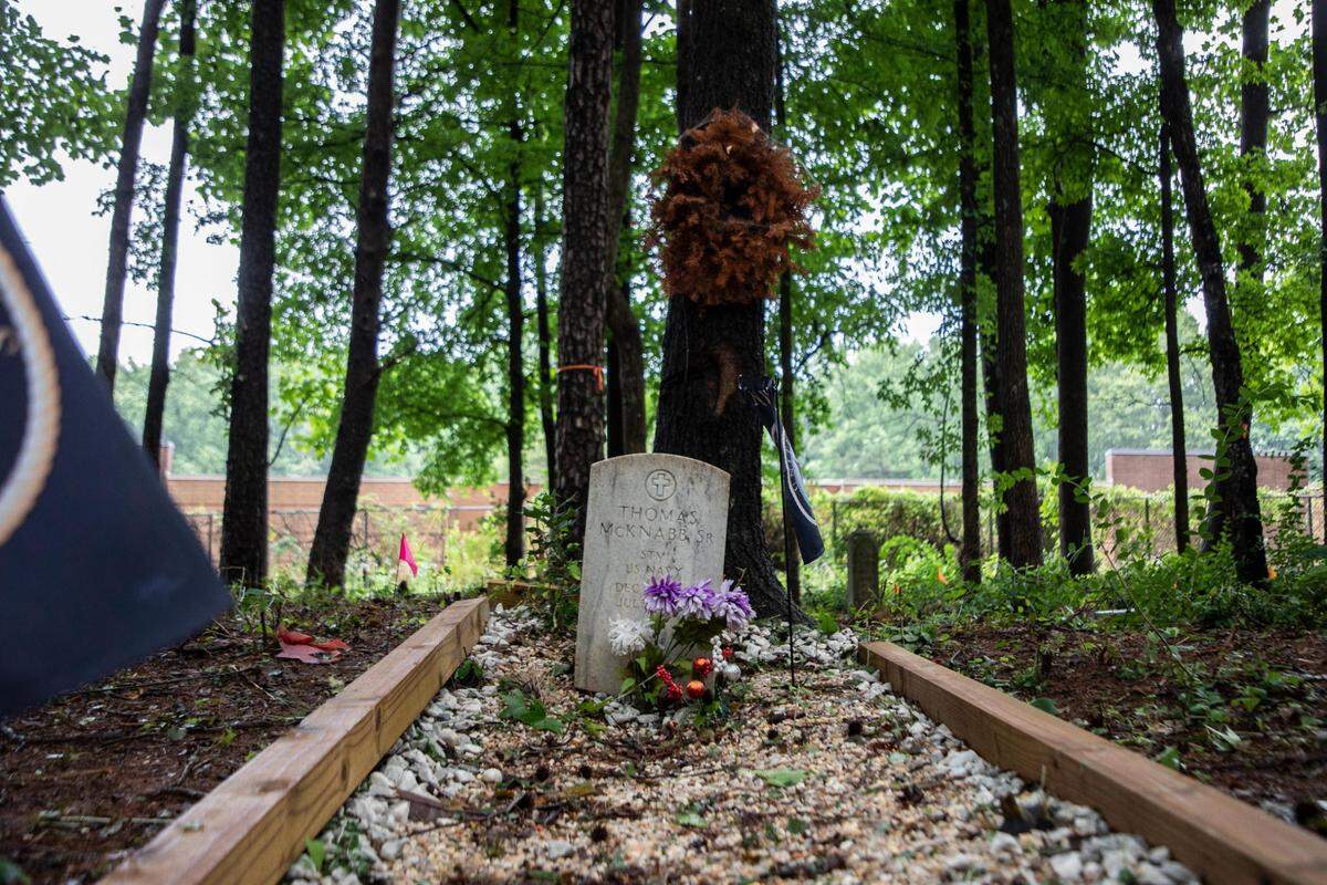 The grave site of Thomas McKnabb Sr. at Cedar Grove Cemetery off Beatties Ford Road in Charlotte. McKnabb served in the U.S. Navy during World War II and was honored at a Memorial Day event on Monday. A number of volunteers have been cleaning up the abandoned cemetery.