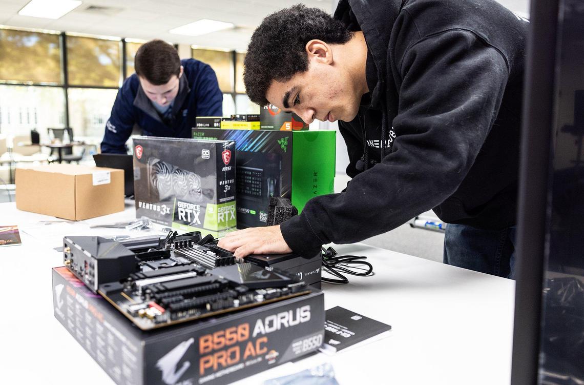 Kaliek Wade starts to build his PC after receiving the components for it at Stiegler Edtech in Charlotte, N.C., on Wednesday, November 23, 2022.
