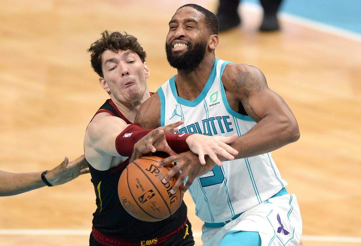 Charlotte Hornets guard Brad Wanamaker, right, is fouled by Cleveland Cavaliers forward Cedi Osman, left, on a drive to the basket Wednesday. Wanamaker scored nine points off the bench for the Hornets in the 103-90 loss.