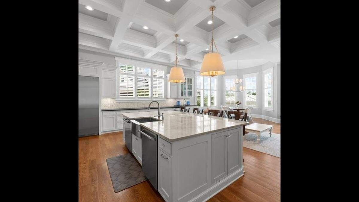 The chef’s kitchen in the mansion includes a $10,000 backsplash, a coffered ceiling and Thermador appliances.