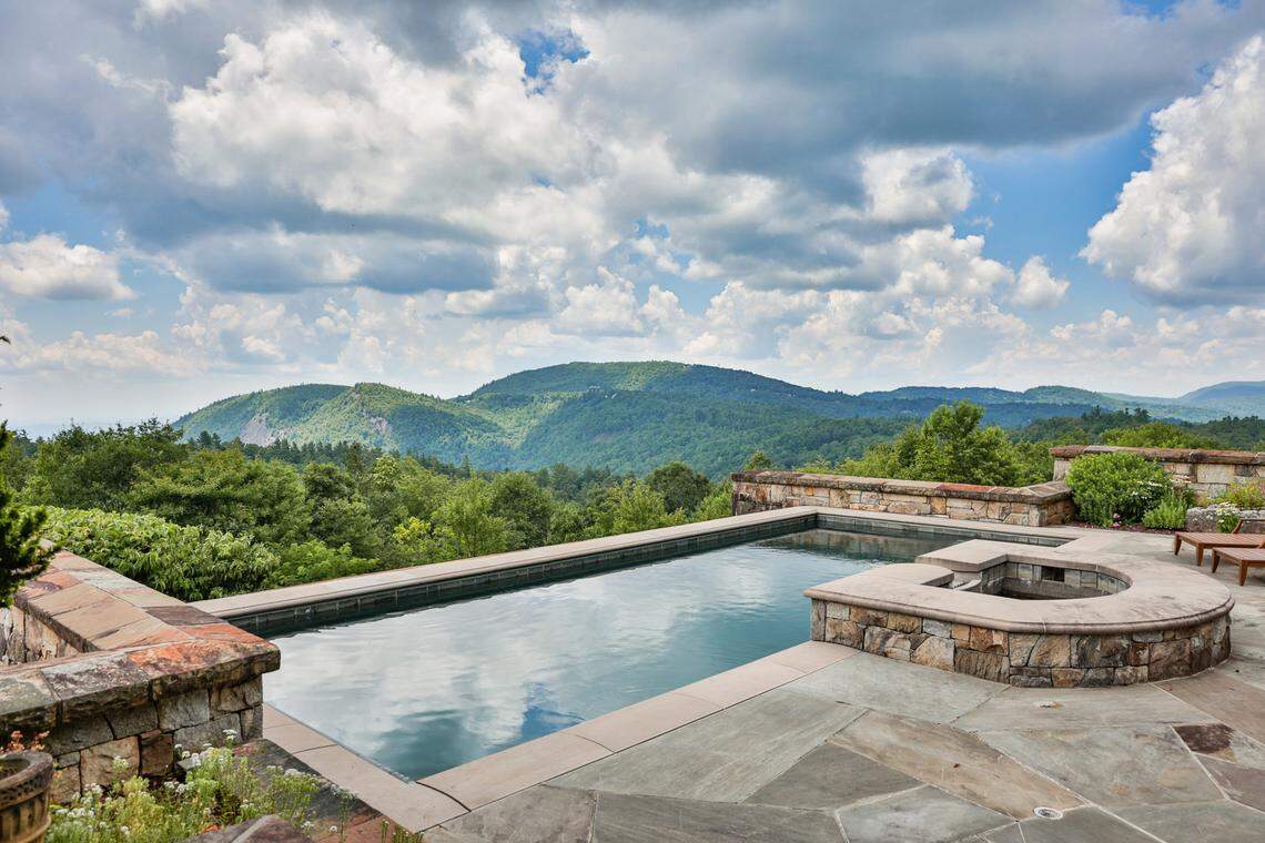 Amenities include a pool pavilion with heated pool, full bath and spa, croquet court and a two-story stone overlook.