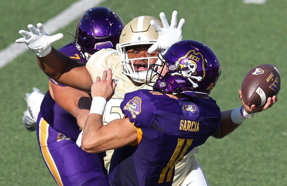 Charlotte 49er’s defensive lineman Colin Coates, center, pressures East Carolina quarterback Jake Garcia, right, on Saturday, October 5, 2024 at Jerry Richardson Stadium in Charlotte, NC.