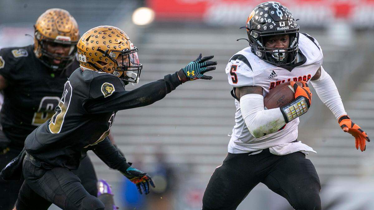 Wallace-Rose Hill’s Kanye Roberts (5) breaks away from Shelby’s Nathan Hopper (19) in the second quarter as he races for a touchdown to take a 21-14 lead during the NCHSAA 2-A championship game on Saturday, December 11, 2021 at Carter-Finley Stadium in Raleigh, N.C.