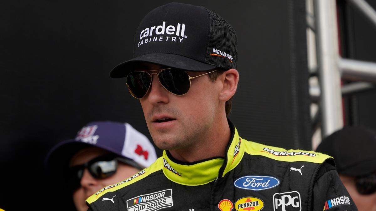 Ryan Blaney waits to be introduced before a NASCAR Cup Series auto race at the Michigan International Speedway in Brooklyn, Mich., Sunday, Aug. 7, 2022. (AP Photo/Paul Sancya)