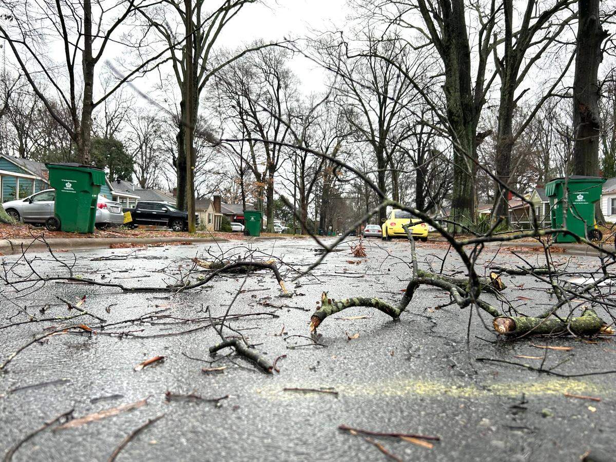 Small tree branches, blown down from the storm earlier this morning, lie strewn over Keswick Avenue in Charlotte, NC on Sunday, December 29, 2024.
