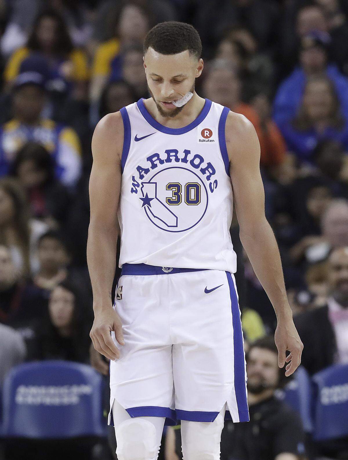 Golden State Warriors guard Stephen Curry (30) walks on the floor during the second half of the team's NBA basketball game against the Atlanta Hawks in Oakland, Calif., Friday, March 23, 2018. (AP Photo/Jeff Chiu)